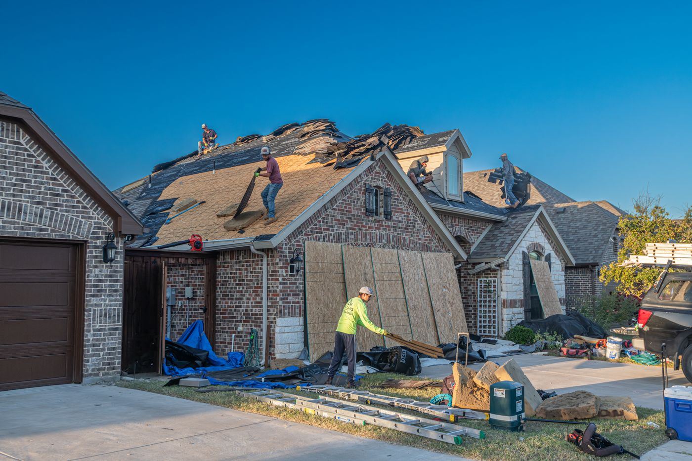 A roofing crew working on a Texas house